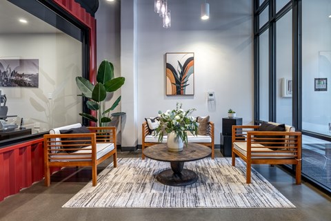 A modern living room with a wooden table and chairs.