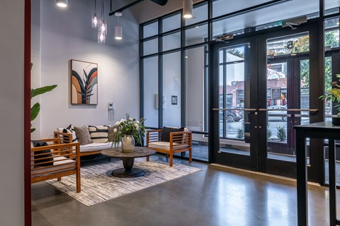 A modern living room with a large window and a view of the street outside.