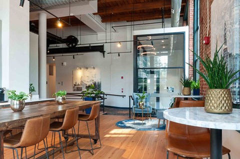 Lobby seating area with exposed wood beams and high ceilings.