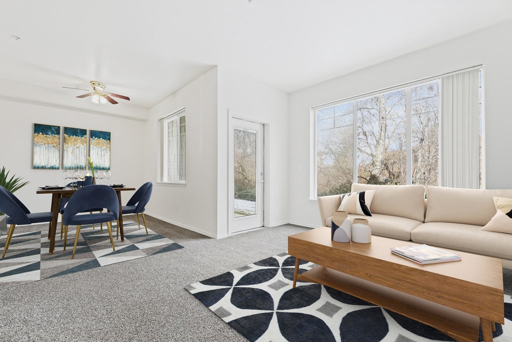 A living room with a dining table and chairs.