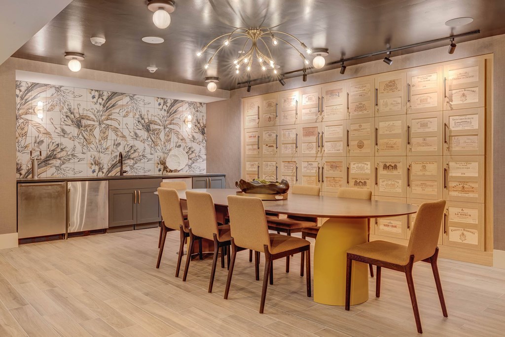 A modern dining room with a large table and chairs.