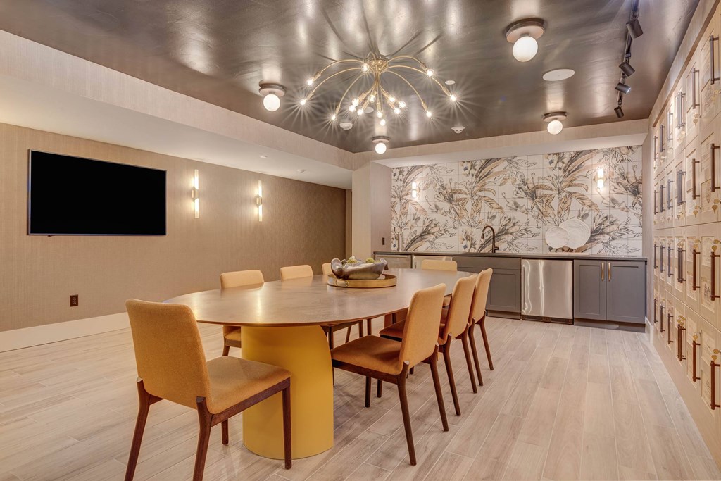 A modern dining room with a round table and chairs.