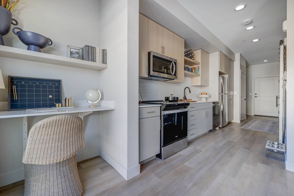 Kitchen with stainless appliances and a built-in desk space at Luma new Salt Lake City apartments.