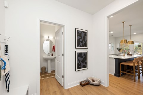 A bathroom with a towel hanging on the wall and a white sink.