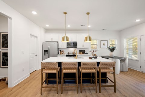 A modern kitchen with a dining table and chairs.