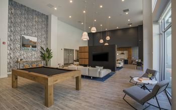 Vinyl Wood-style Flooring in a living room with a pool table and a tv at Metro Mission Valley,  92108