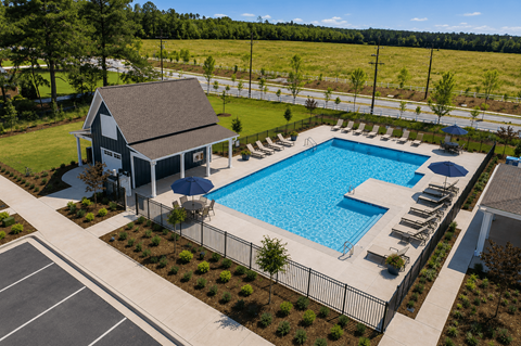 A pool with a house and a fence.