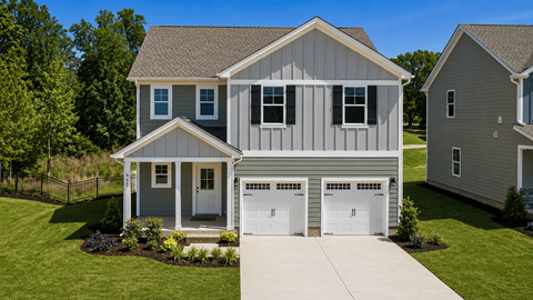 A two-story house with a garage is surrounded by a well-kept lawn.
