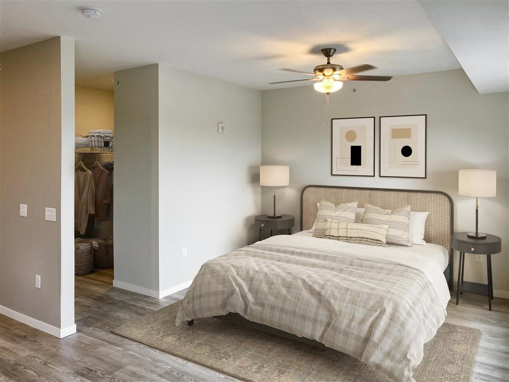 a bedroom with a bed and a ceiling fan