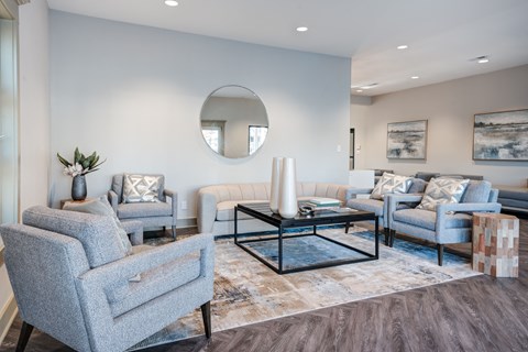 A living room with grey chairs and a coffee table.