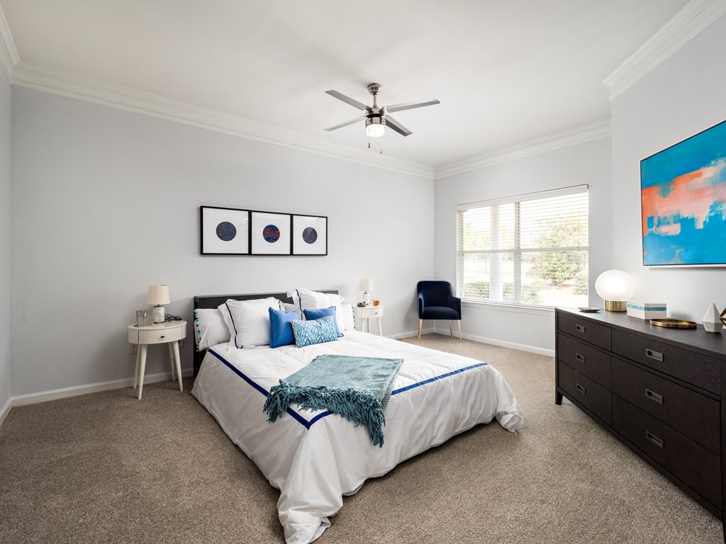 a bedroom with a bed and a ceiling fan