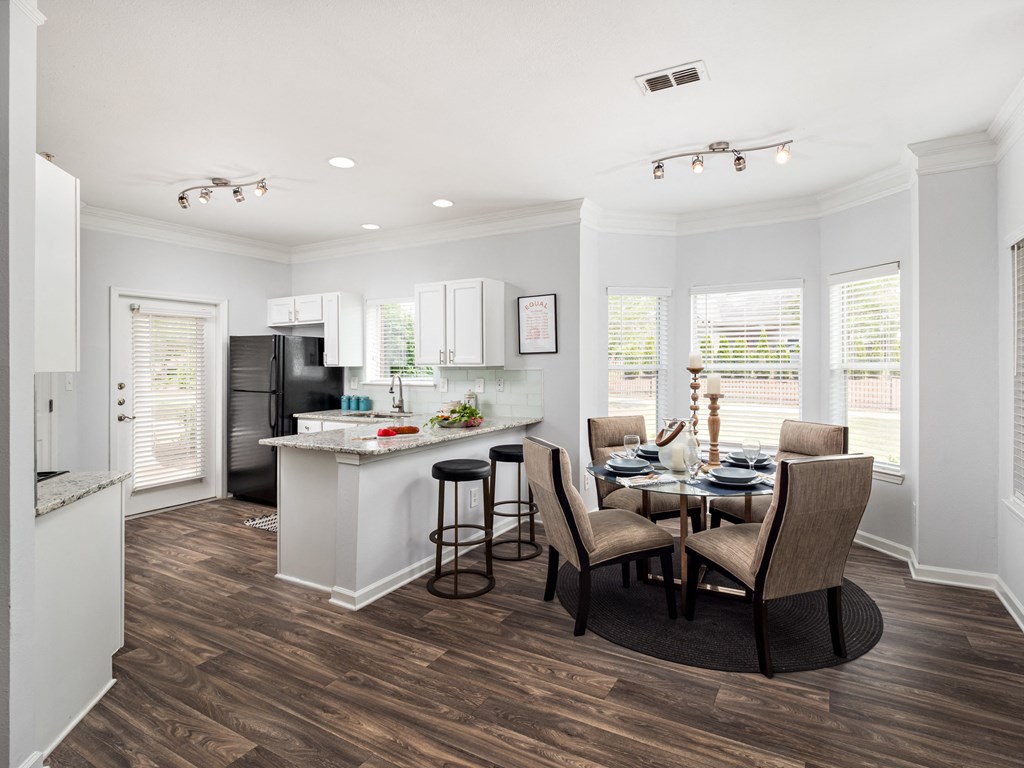 a kitchen and dining room with a table and chairs