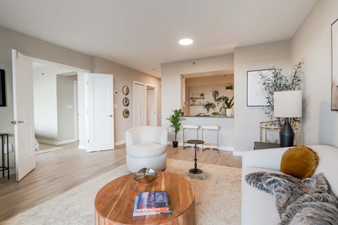 A modern living room with a white sofa and a coffee table.