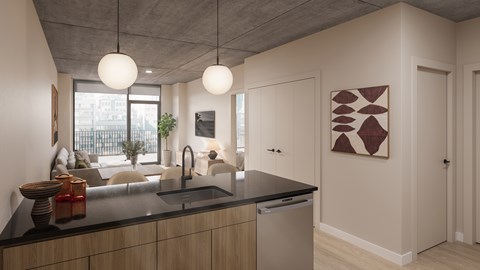 A modern kitchen with a black countertop and a large window.