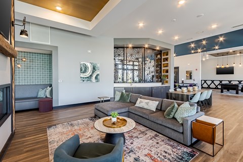 A modern living room with a grey sofa and a wooden coffee table.