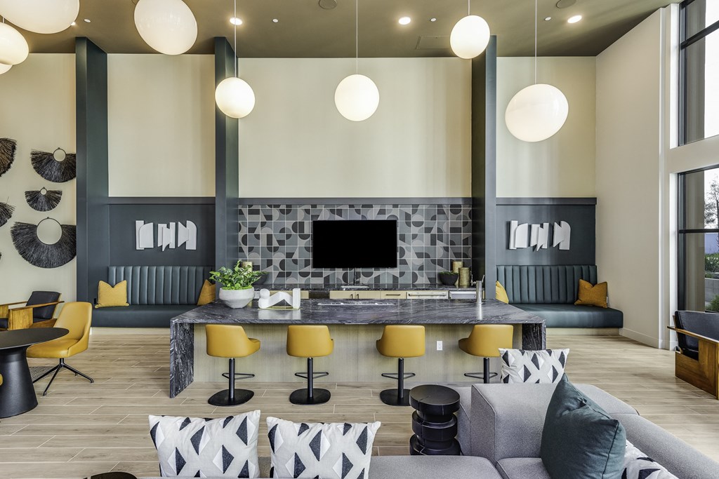 A modern living room with a fireplace and yellow chairs.