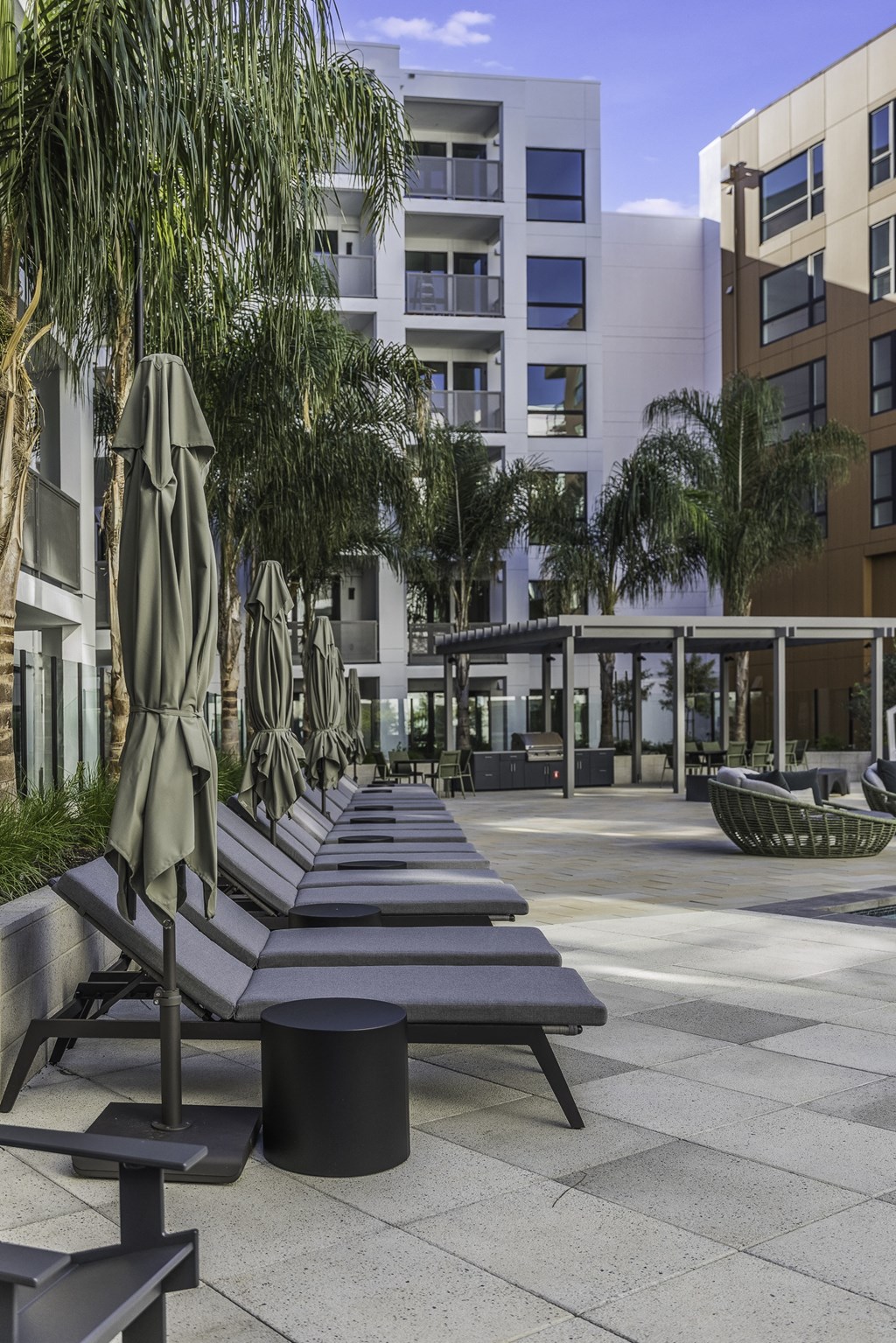 A row of benches are lined up in a courtyard.