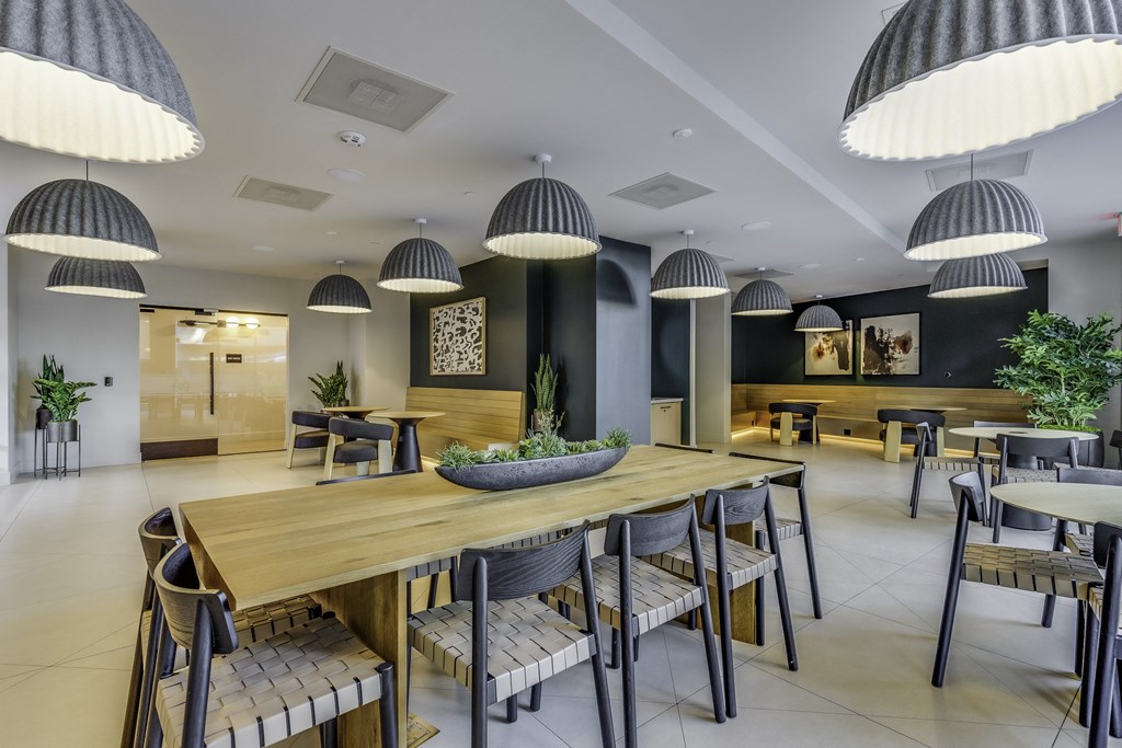A modern dining area with wooden tables and chairs.