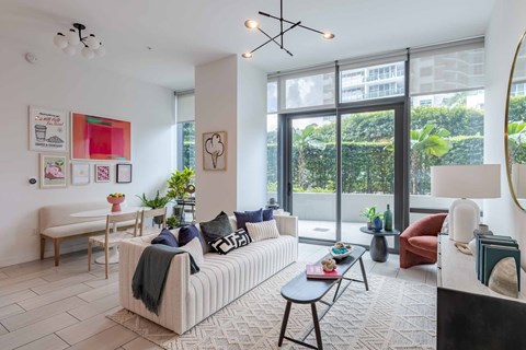 A living room with a sofa, a table, and a couch.