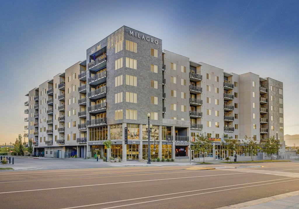 A large, modern apartment building named Milagro is shown.