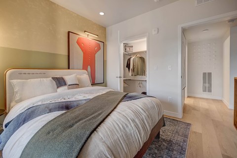 A bedroom with a large bed and a wardrobe.