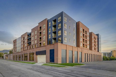 A modern apartment building with a mix of brick and panel facades.