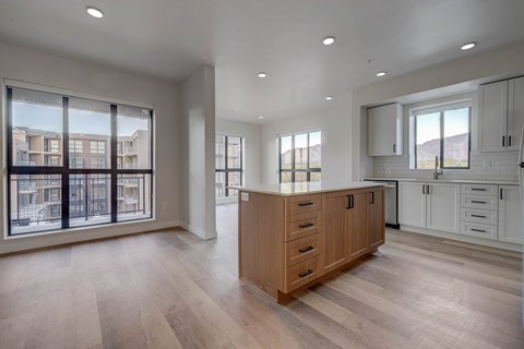 A spacious kitchen with wooden cabinets and a large island.