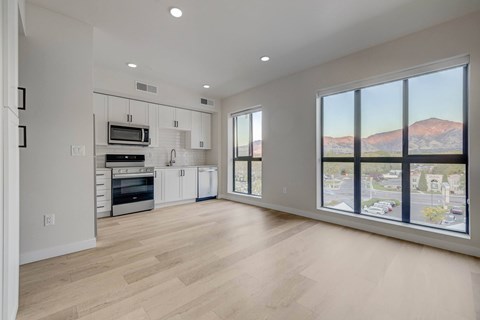 A spacious kitchen with white cabinets and a microwave above the oven.