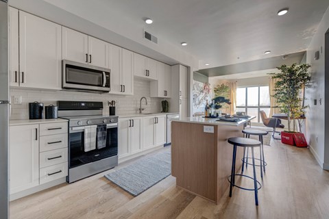 A modern kitchen with a bar stool and a countertop.
