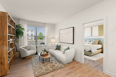 A living room with a white couch, a coffee table, and a painting on the wall.