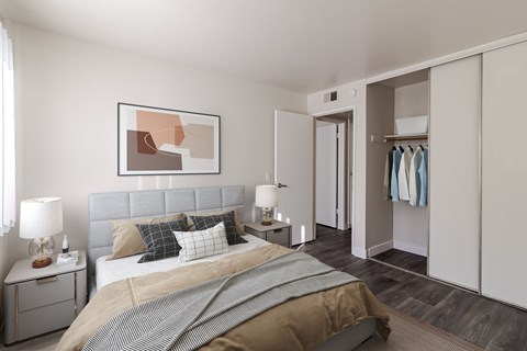 A bedroom with a large bed and a painting on the wall.