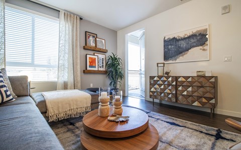 a living room with a couch and a bed and a coffee table
