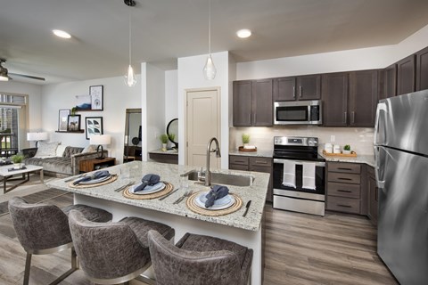 A modern kitchen with a dining table and chairs.