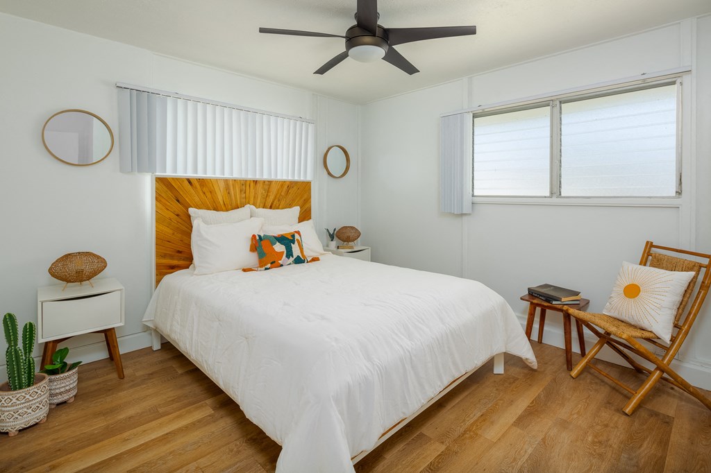 a bedroom with a bed and a ceiling fan
