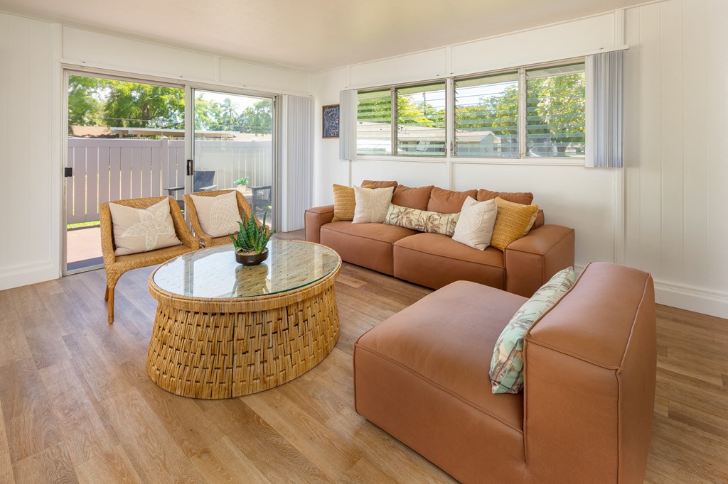 a living room with brown couches and a round table