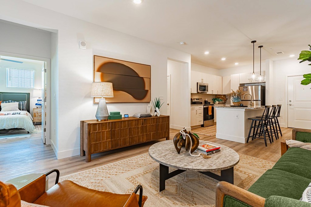 A living room with a brown wooden bench and a green sofa.