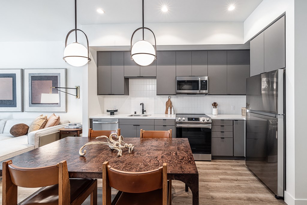 an open kitchen and dining room with a table and chairs
