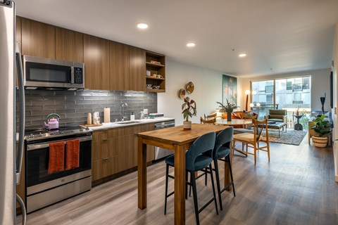 A modern kitchen with a wooden table and chairs.