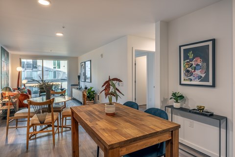A dining room with a wooden table and chairs.