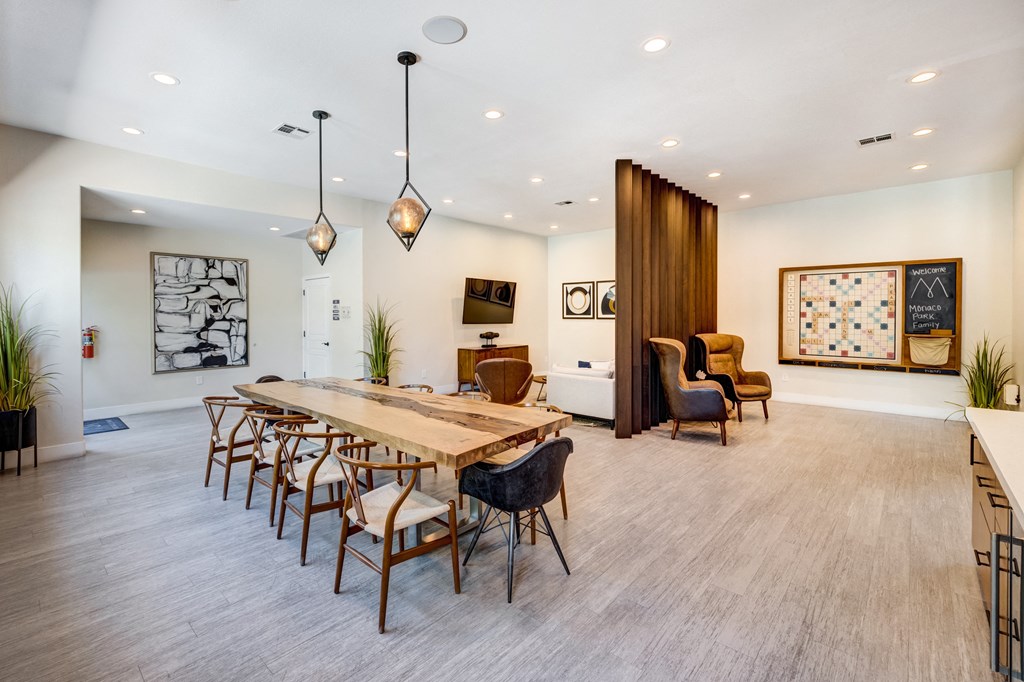 a conference and game room with a long wooden table and chairs