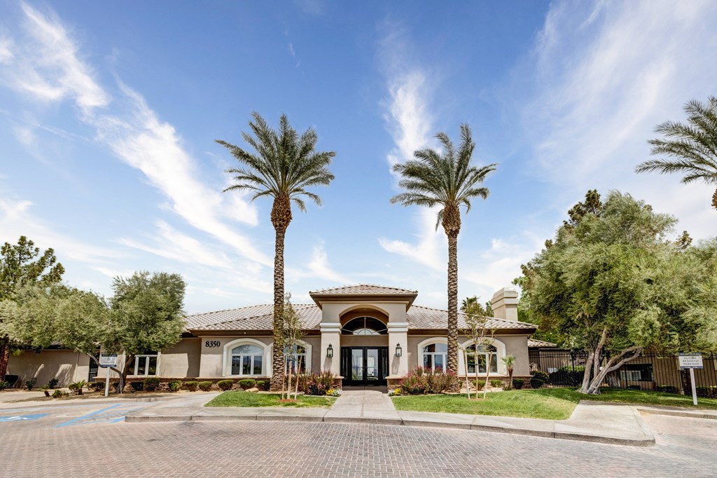 leasing office with palm trees in front of it