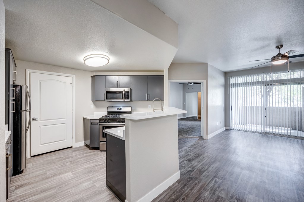 a kitchen and living room with a large window