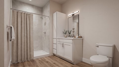 A bathroom with a toilet, a sink, and a shower.