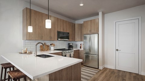 A modern kitchen with wooden cabinets and a white countertop.
