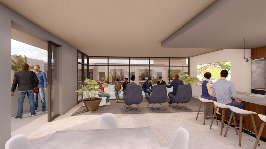 A group of people are gathered in a modern room with a glass wall.