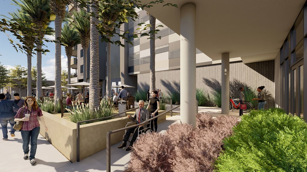 A modern outdoor seating area with people walking and sitting.