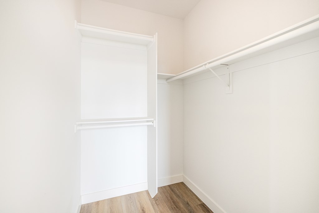 A white door is in a white room with a white wall.