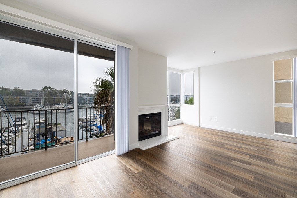A living room with a fireplace and sliding glass doors.