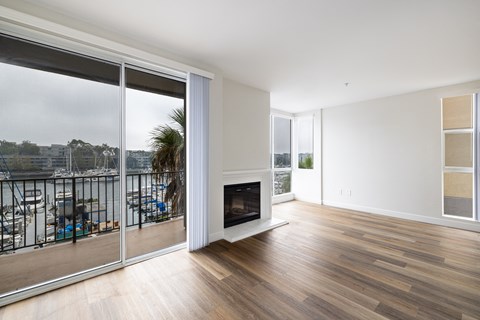 A living room with a fireplace and sliding glass doors.