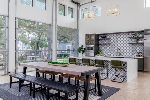 Communal table and kitchen with island in the resident lounge